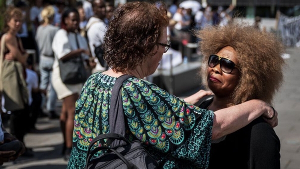 Bridget Efe (R), the wife of Mike Ben Peter, is comforted after the verdict