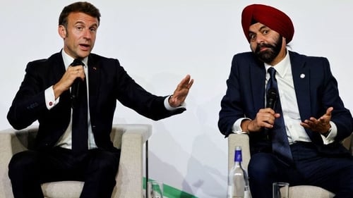French President Emmanuel Macron (L) with World Bank President Ajay Banga at the summit