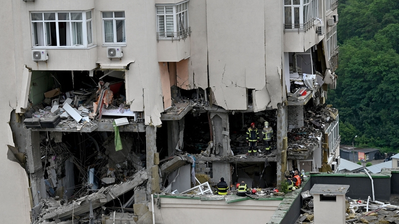 Rescuers work in a 24-storey building partially destroyed as a result of missiles strikes in Kyiv