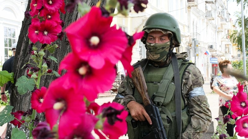 A member of Wagner group stands guard in a street in the city of Rostov-on-Don