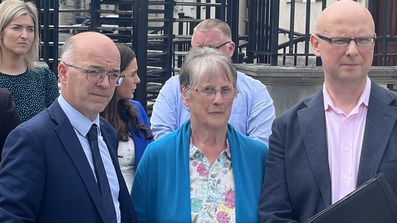 Solicitor Adrian O'Kane, Teresa Kelly and Patsy Kelly Jnr outside the High Court in Belfast