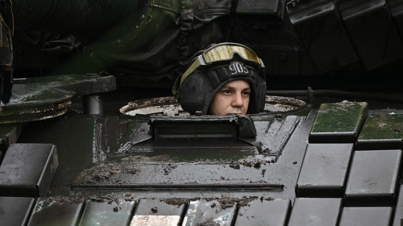 A Ukrainian serviceman sits on a T-72 tank at a position in the Donetsk region