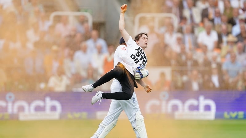 Bairstow carries one of the protesters from the field