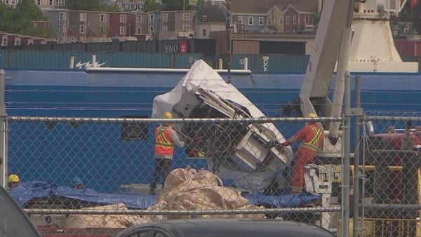 Images showed a crane unloading the wreckage from the Horizon Arctic ship in the city's harbour