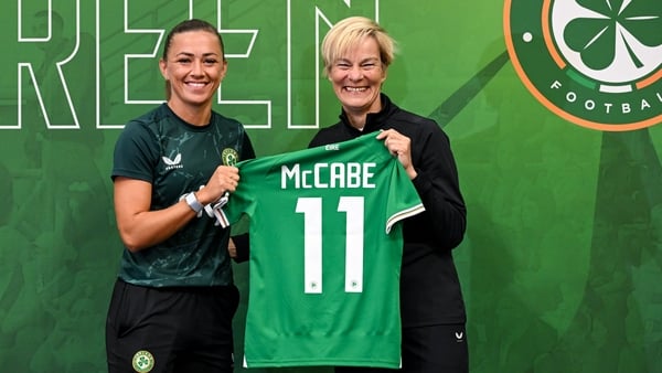 Vera Pauw (R) presents Katie McCabe with her squad shirt