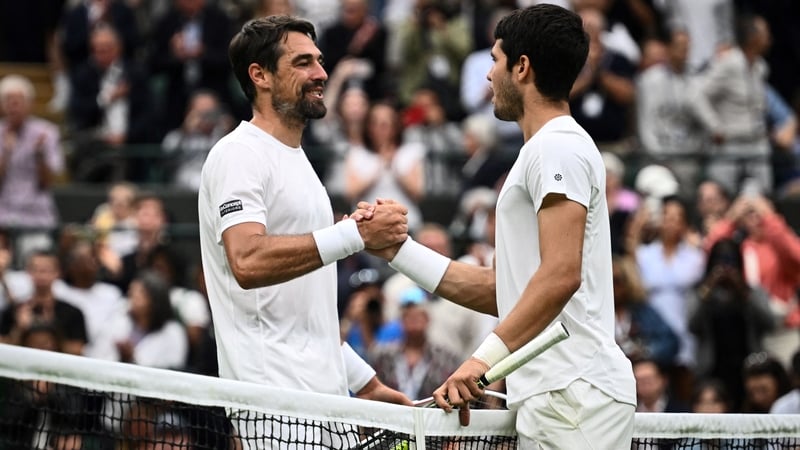 Jeremy Chardy shakes hands with Carlos Alcaraz after his last professional singles match