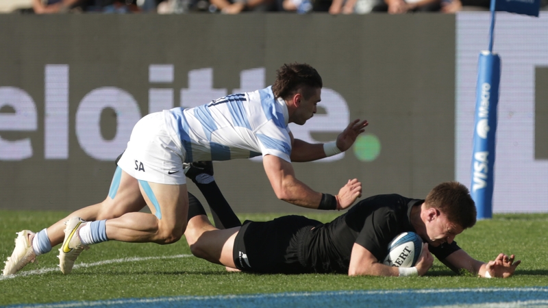 Jordie Barrett of New Zealand crashes over the whitewash despite the best efforts of Argentina's Mateo Carreras