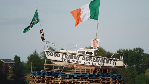 The pyre with a boat on top, with an Irish flag and a picture of Taoiseach Leo Varadkar before it was set alight (pic: PA)