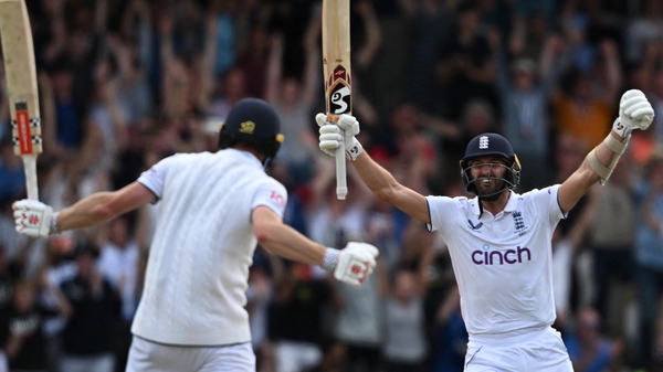 England's Mark Wood (right) celebrates with Chris Woakes