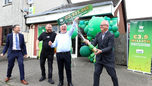 Pinewood Stores owner David Fitzgibbon, second left, celebrates with staff member Joey Kelly, second right, and the National Lottery's David Woods and Jim O'Connor