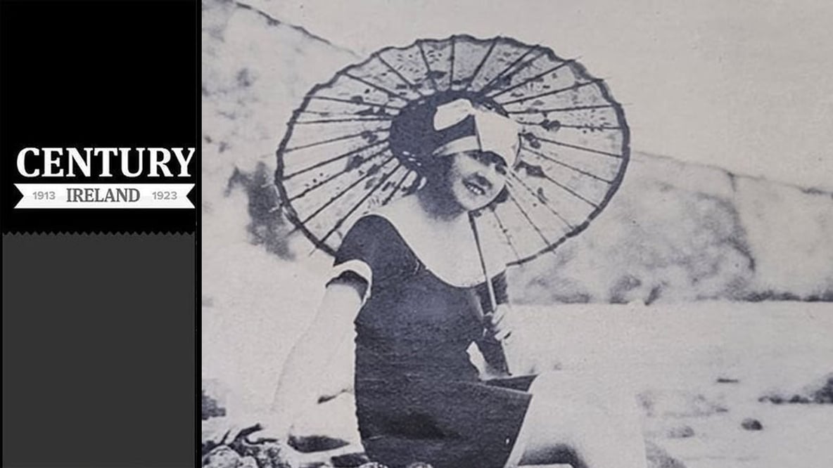 Century Ireland Issue 261 - 'The rocks at Tramore present all kinds of pleasant scenes during the summer months. Young woman on rocks with umbrella. Photo: Irish Life, August 1923