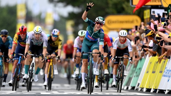 Jasper Philipsen celebrates after crossing the finish line