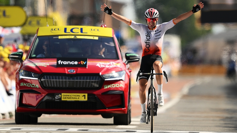 Ion Izagirre celebrates with his Team Cofidis car behind him