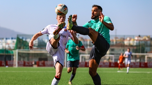 Dundalk's Daniel Kelly (L) competes for the ball with Joseph Chipolina