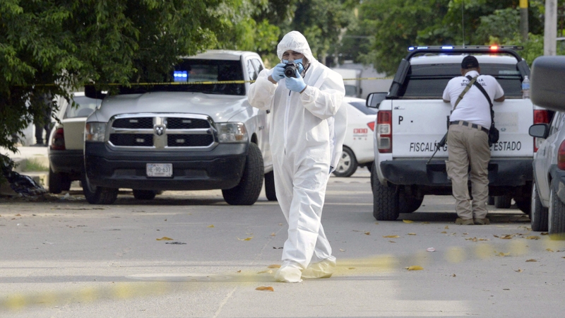 Crime scene investigators examine the area where Nelso Matus was killed