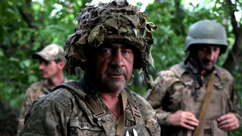A Ukrainian artilleryman poses as he holds a position at the frontline near the town of Bakhmut
