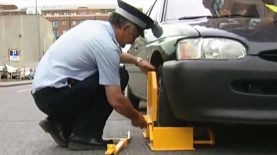 Clamper in action in Dublin city centre, 1998.