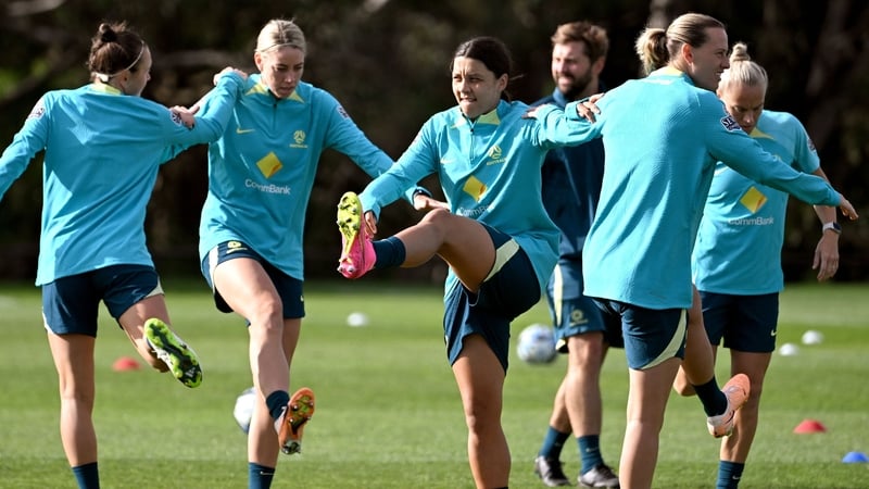 Sam Kerr (C) goes through some stretches during Australia training