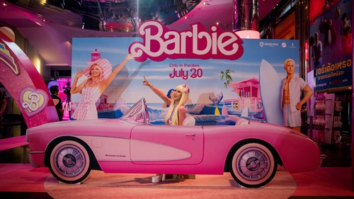 A Barbie fan poses in a carboard car at the Barbie movie premiere in Bangkok