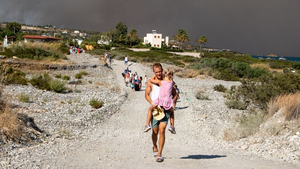 Tourists are evacuated as a huge wildfire rages across Greece's Rhodes island