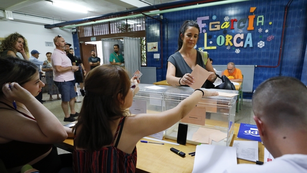 A woman casts her ballot during the general elections in Granada, Spain