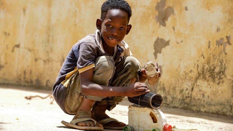 A displaced child in the courtyard of the university of Al-Jazira, transformed into a makeshift shelter, in al-Hasahisa south of Khartoum