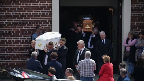 Coffins carrying the remains of Eoin Fitzpatrick and his son Dylan are taken from the church following the funeral mass
