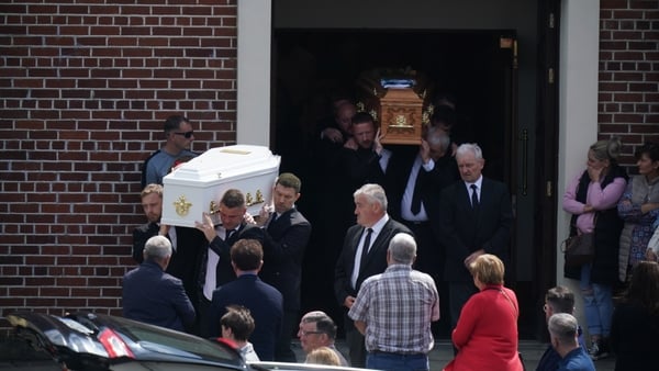 Coffins carrying the remains of Eoin Fitzpatrick and his son Dylan are taken from the church following the funeral mass