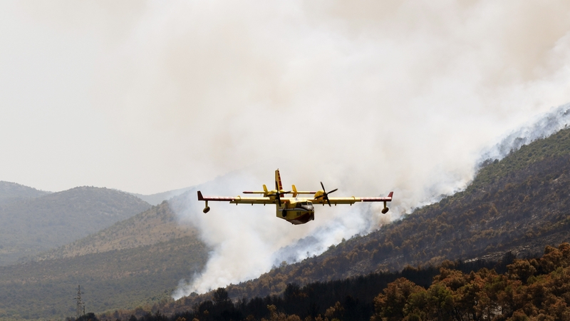 A tanker plane drops water on a fire in Grebastica, Croatia
