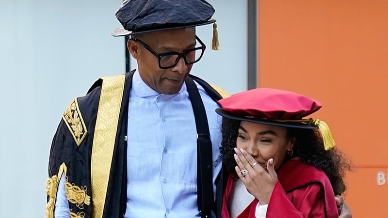 Chancellor of Buckinghamshire New University Jay Blades watches Leigh-Anne Pinnock react to a group of students from the BNU Dance Club performing a flash mob for her ahead of her receiving an honorary doctorate at Buckinghamshire New University