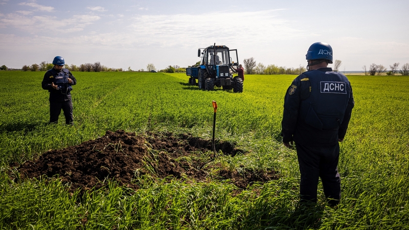 Members of a demining team prepare to destroy an unexploded missile in the Zaporizhzhia region