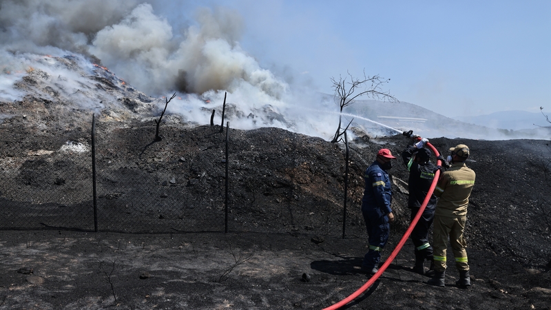 Firefighters extinguish a wildfire in Volos, Greece