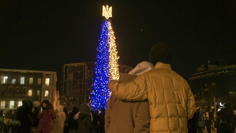 A couple viewing the Christmas tree in central Kyiv's Sofiyska Square last year
