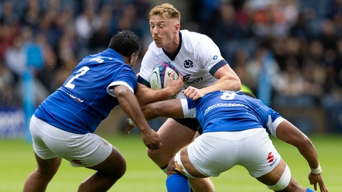 Scotland's Ben Healy is tackled by Italy's Toa Halafihi and Epalahame Faiva
