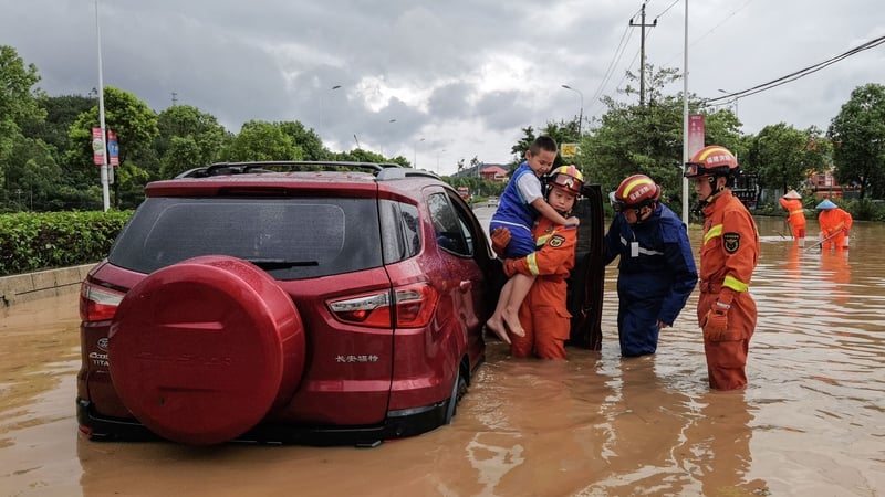 Rescuers come to the aid of residents in a flooded area in Quanzhou, eastern Fujian
