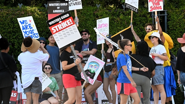Members of SAG-AFTRA and WGA walk the picket line earlier this year