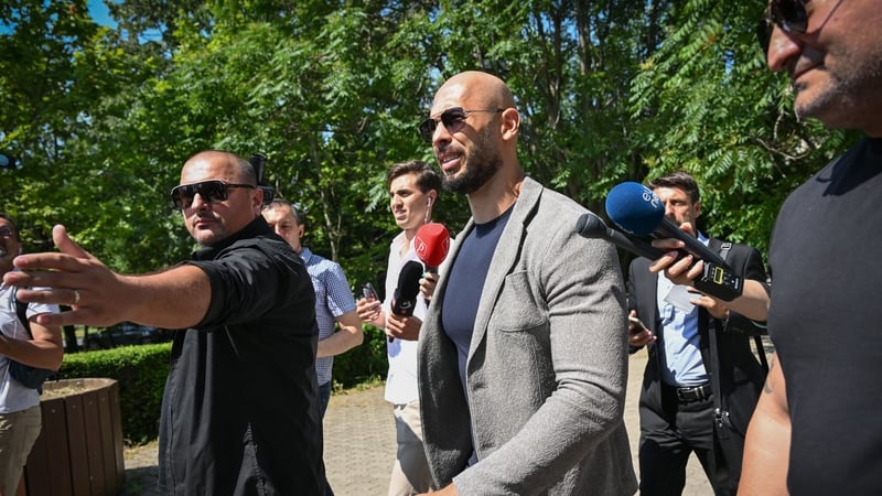 Andrew Tate (grey jacket) pictured as he arrived for a court hearing in June
