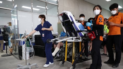 A participant is carried on a stretcher at Jamboree Hospital