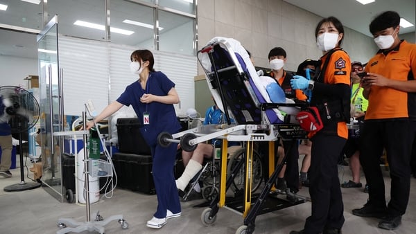 A participant is carried on a stretcher at Jamboree Hospital