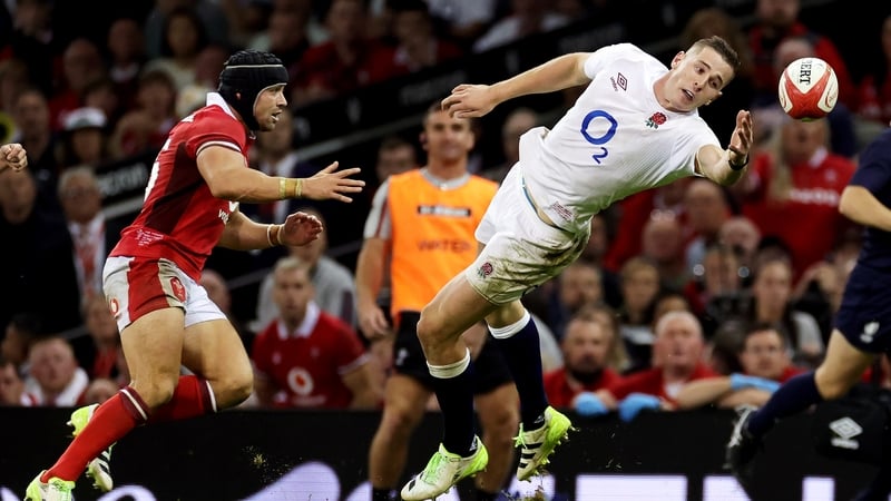 England's Freddie Steward contends for the aerial ball whilst under pressure from Leigh Halfpenny of Wales
