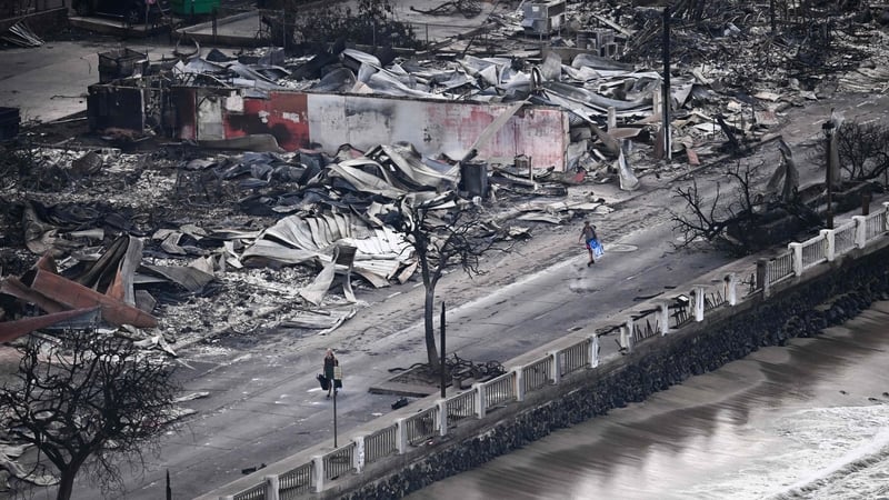 A person walking past destroyed buildings burned to the ground in Lahaina in the aftermath of wildfires in western Maui, Hawaii. Photo: Patrick T. Fallon/AFP via Getty Images