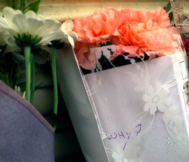 The day after the bombing, floral tributes are left nearby. A message on a bunch of flowers left at the cordoned-off end of Market Street simply reads, 'Why?'