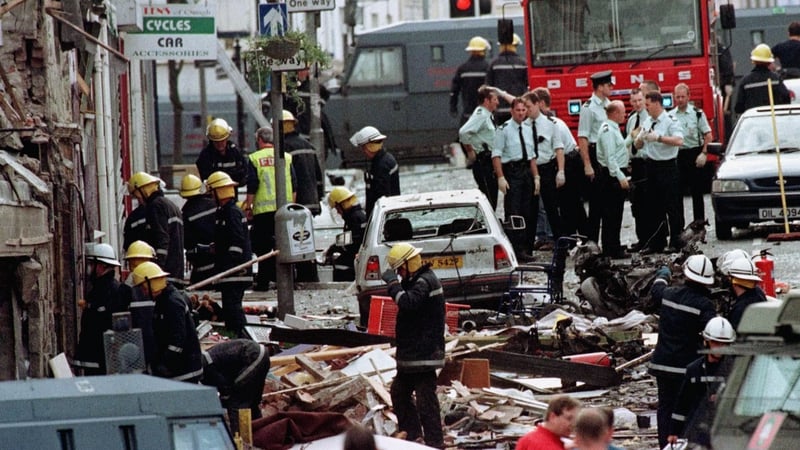 Firefighters and policemen inspect the damage after the bomb exploded in Omagh in 1998