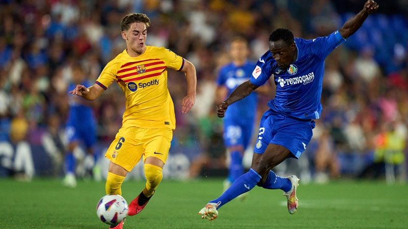 Gavi of FC Barcelona competes for the ball with Djene Dakonam of Getafe CF
