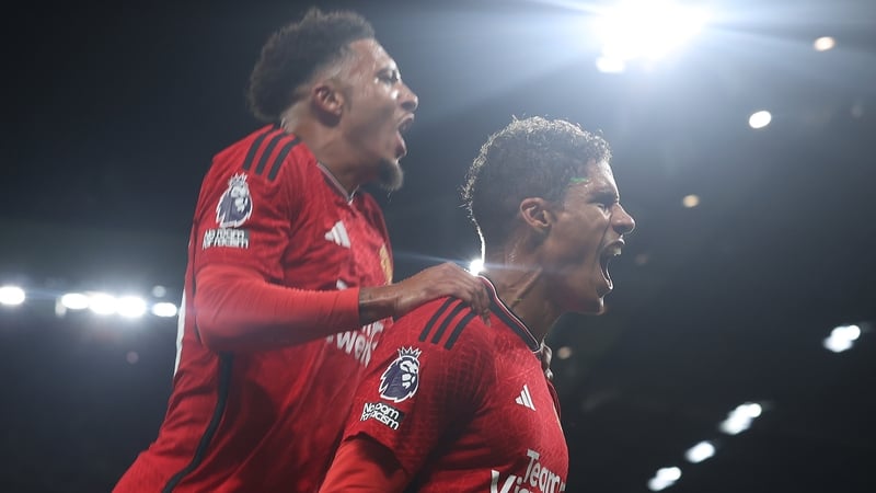 Varane (R) celebrates scoring the winner with team-mate Sancho