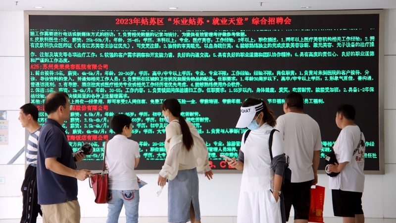 Job seekers check job postings at a job fair in Suzhou, Jiangsu province, China