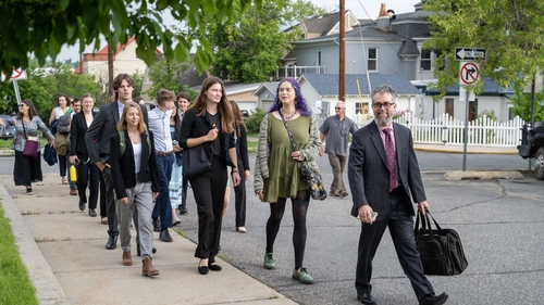 The plaintiffs are pictured as they arrive for the start of the trial in June