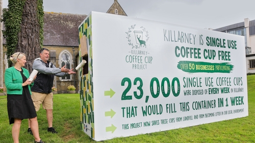 Alice Thompson and Alan Oliver handing in single-use coffee cups into the box in Killarney town centre