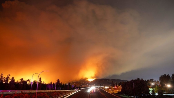 A wildfire burns in the hills of West Kelowna, British Columbia
