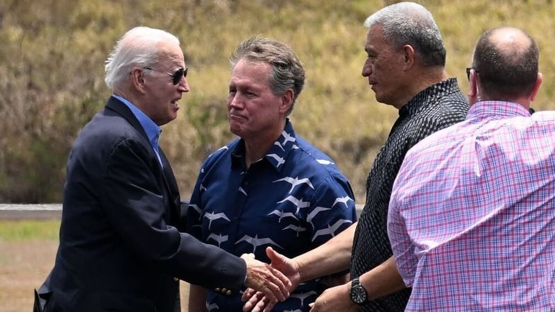 Joe Biden greets officials including Maui County Mayor Richard Bissen (2R) at Kapalua Airport